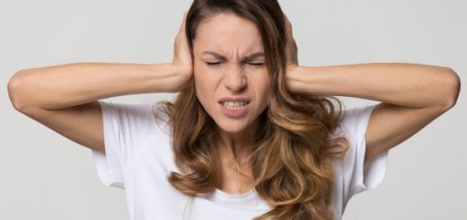 Annoyed stressed woman cover ears feel hurt ear ache pain otitis suffer from loud noise sound headache, irritated stubborn girl deaf hear not listen to noisy music isolated on white studio background (Annoyed stressed woman cover ears feel hurt ear ac